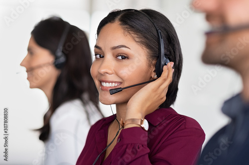 Young latin woman in customer service center