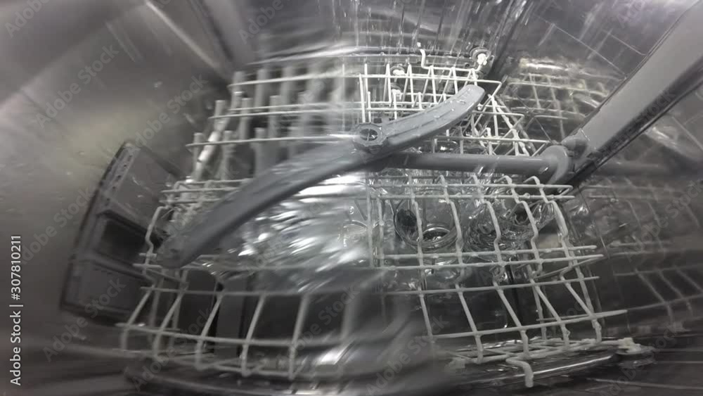 Slow motion. The master repairs the dishwasher and checks the operation