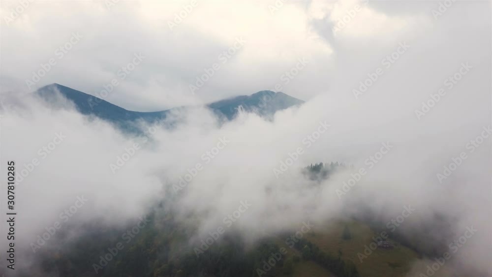 4K .Aerial beautiful  landscape .Fly in clouds in mountain area,