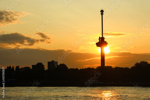 Euromast in Rotterdam towering over the city with a beautiful sunset behind it