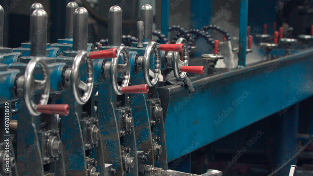 Steel cog gear set of metal sheet bending machine in a metalwork factory. Steel cog gear set of metal sheet bending machine in a metalwork factory.
