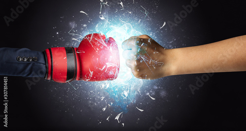 Two hands fighting and breaking glass into small pieces with blue light concept © ra2 studio