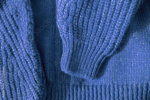 Blue wool sweater, above. Close-up knitting woven cardigan texture. Color of the year 2020 background