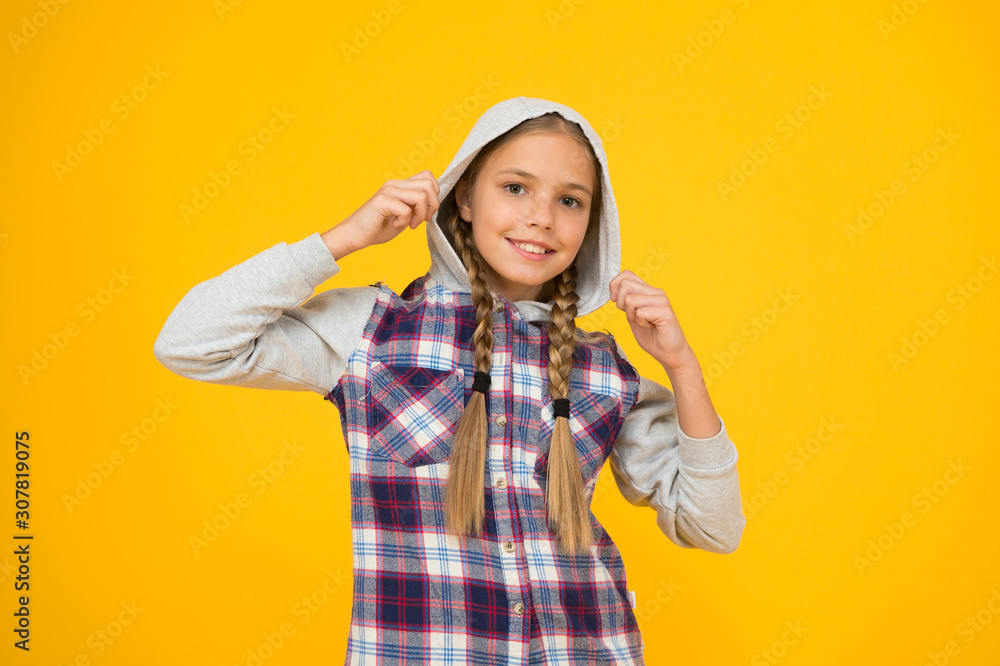 Casual style. Cute braided girl. Kid long hair. Small girl checkered shirt. Happy international childrens day. Little girl yellow background. Good mood concept. Positive vibes. Sincere emotions Casual style. Cute braided girl. Kid long hair. Small girl checkered shirt. Happy international childrens day. Little girl yellow background. Good mood concept. Positive vibes. Sincere emotions