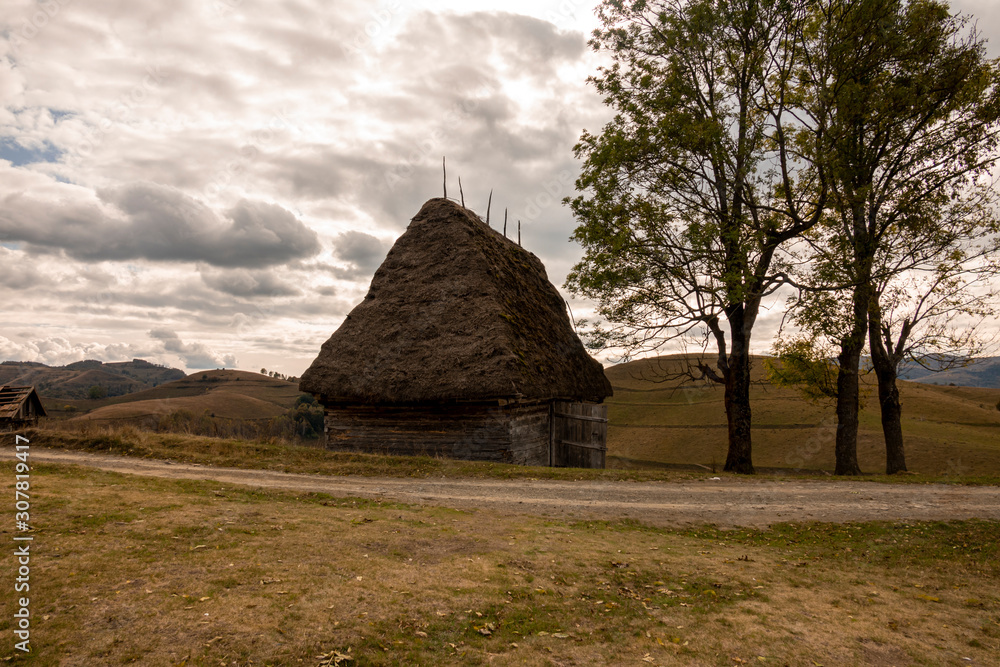 small wooden house with thatched roof in the mountains. small wooden house with thatched roof in the mountains.