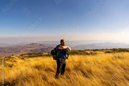 man tourist photographer on a mountain. © zane38