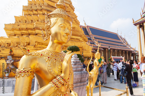 Elegant golden Kinnari statue at Grand Palace. photo
