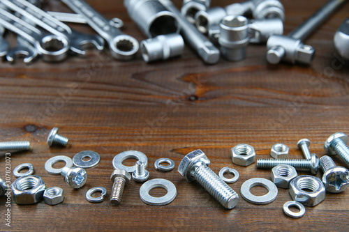 bolts and nuts on a wooden background