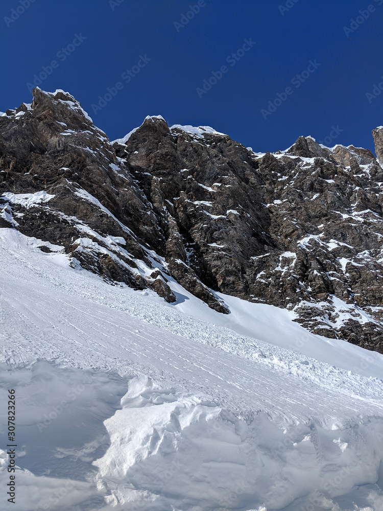 scenic view of snow covered mountains against clear blue sky