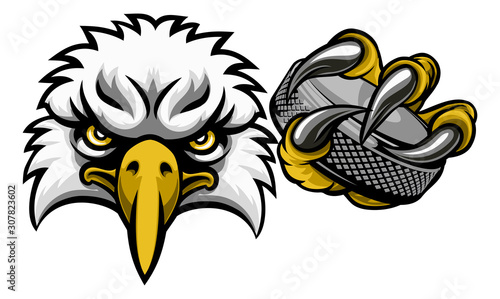 An eagle ice hockey player animal sports mascot holding a puck