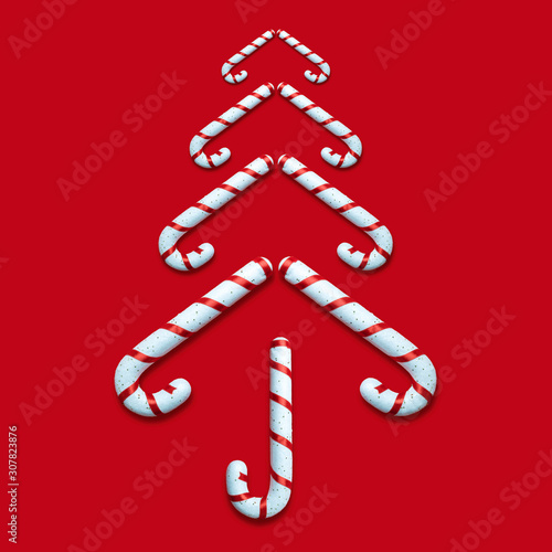 Candy canes in form of Christmas tree on red background holiday abstract.