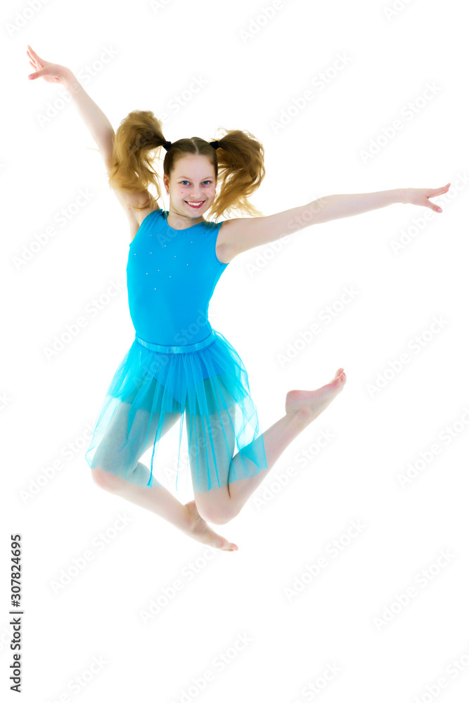 The girl gymnast performs a jump.