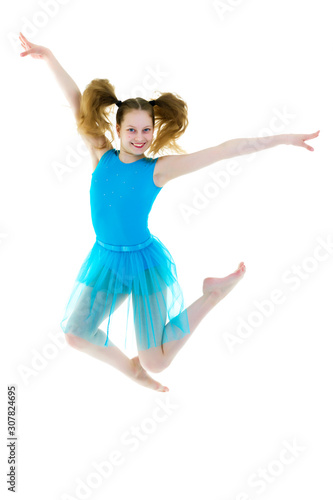 The girl gymnast performs a jump.