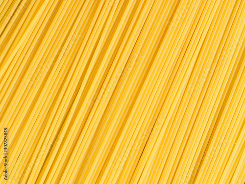 Background of long yellow pasta. Healthy eating concept