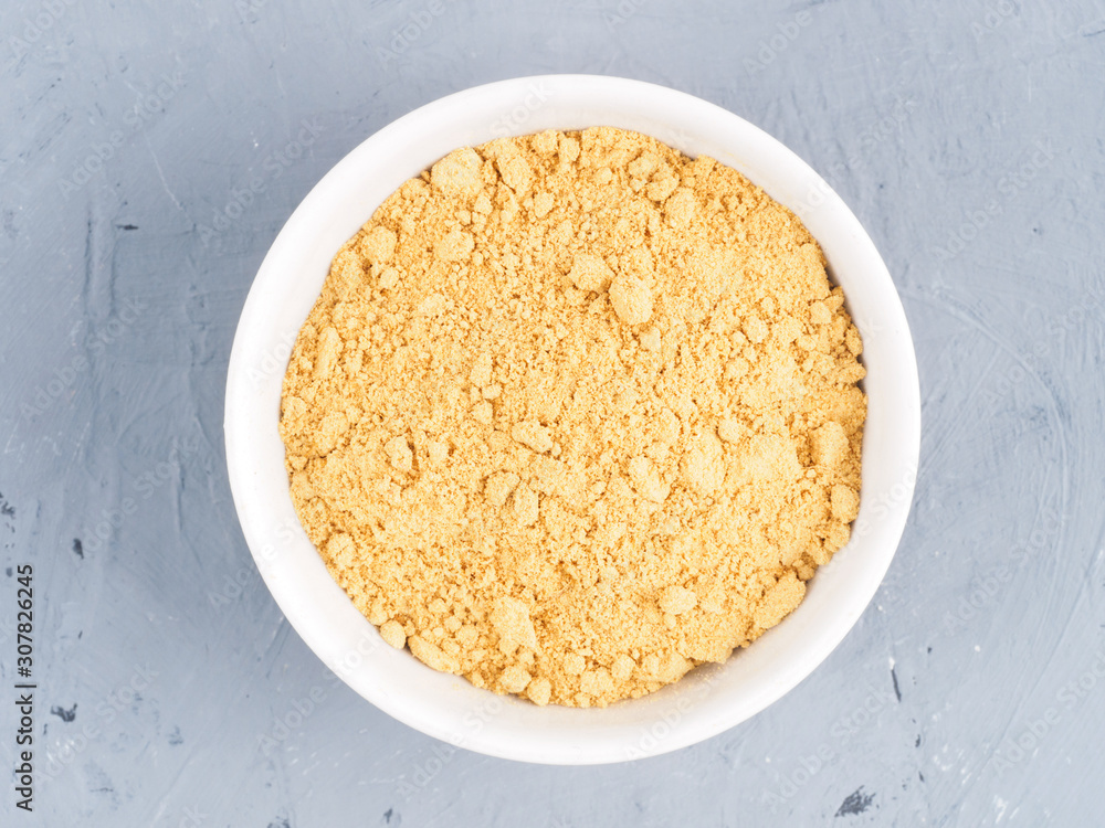 Dry ginger in a white bowl on a gray concrete background. Healthy eating concept Dry ginger in a white bowl on a gray concrete background. Healthy eating concept