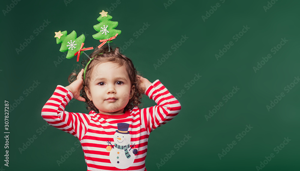 cute caucasian girl kid infant christmas tree headband concept green background festive minimalism new year decoration cute caucasian girl kid infant christmas tree headband concept green background festive minimalism new year decoration