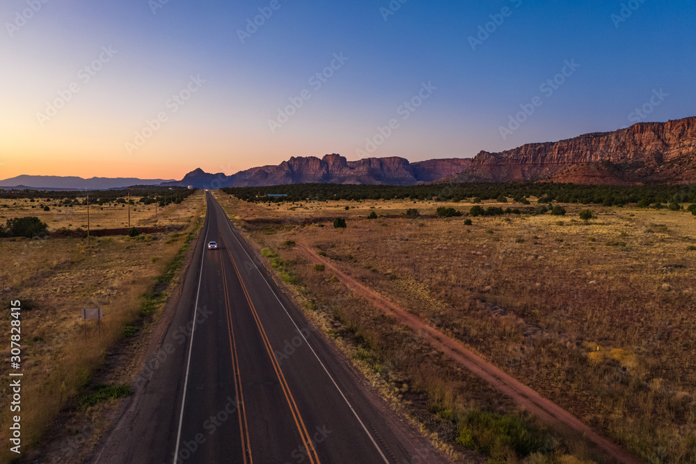 Top view of highway, close to Colorado city. Cottonwood point. Sunset sky, mountains. Arizona, USA