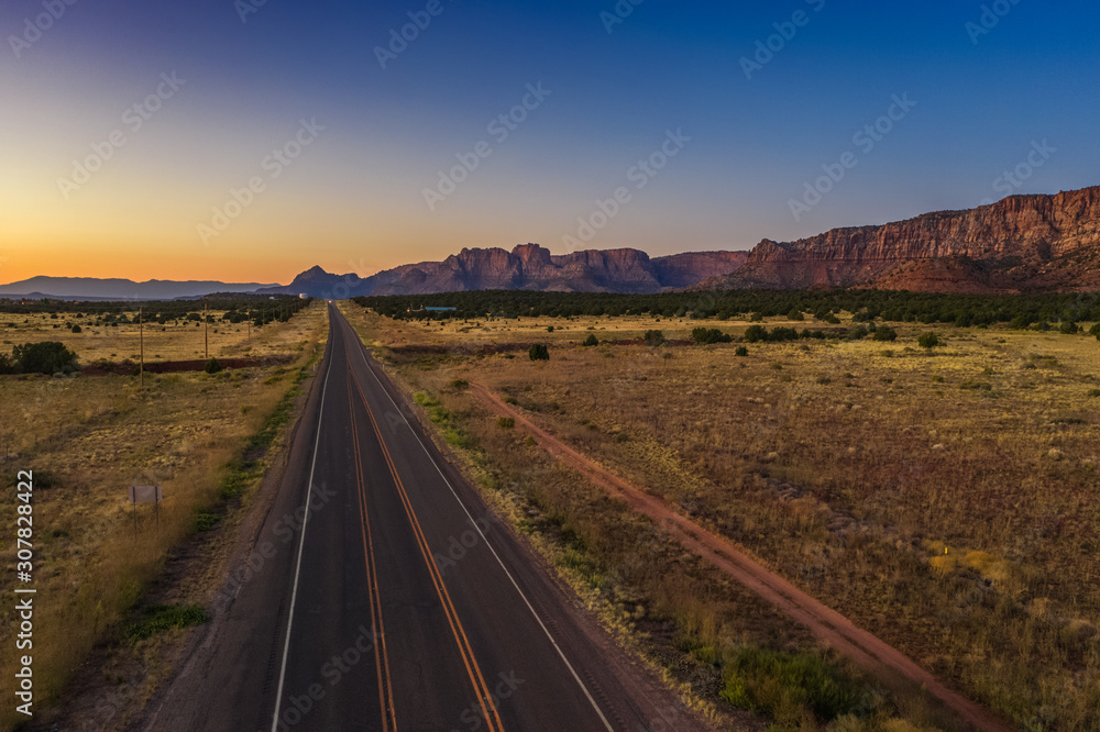 Top view of highway, close to Colorado city. Cottonwood point. Sunset sky, mountains. Arizona, USA