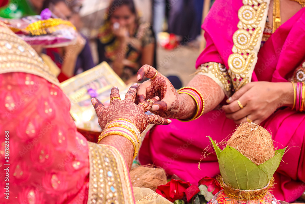 Indian engagement ceremony : Bride and groom putting a wedding engagement  ring on finger Stock Photo | Adobe Stock