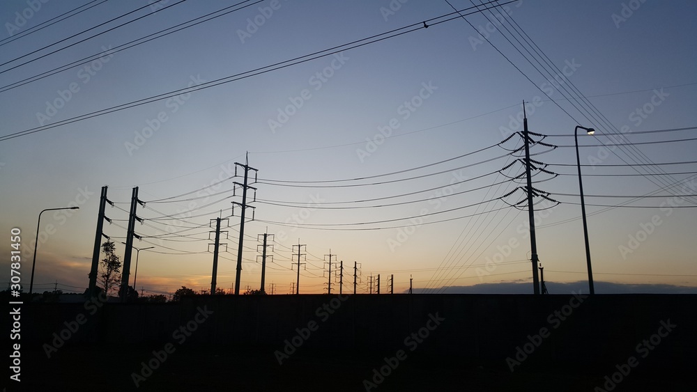 The sunset and High voltage electric pole silhouette