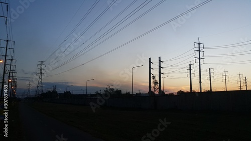 The sunset and High voltage electric pole silhouette