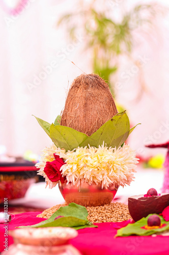 Indian wedding ceremony : decorative coper kalash with green leaf and coconut 