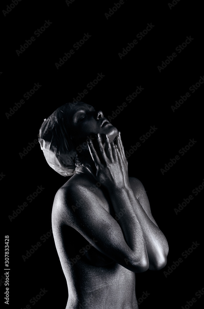 Young fit athletic woman in silver body paint posing Young fit athletic woman in silver body paint posing