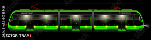 Modern green tram at night on the street. Side view. Eco-friendly electric transport. Way to work and home.