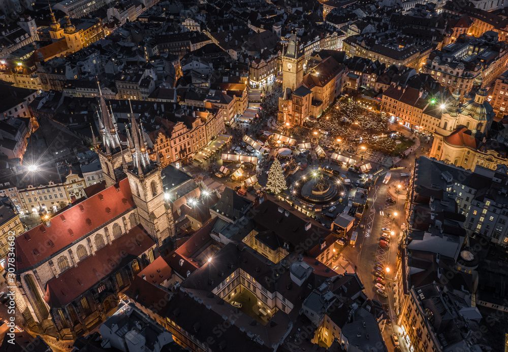Prague, Czech Republic - Aerial drone view of the famous illuminated Church of our Lady Before Tyn towers at blue hour with traditional Christmas market, Old Town Square & Old Town Hall at background Prague, Czech Republic - Aerial drone view of the famous illuminated Church of our Lady Before Tyn towers at blue hour with traditional Christmas market, Old Town Square & Old Town Hall at background