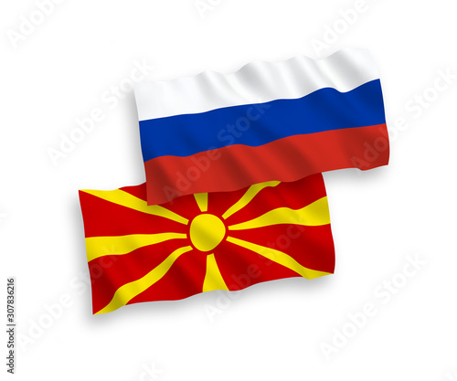 National vector fabric wave flags of North Macedonia and Russia isolated on white background. 1 to 2 proportion.