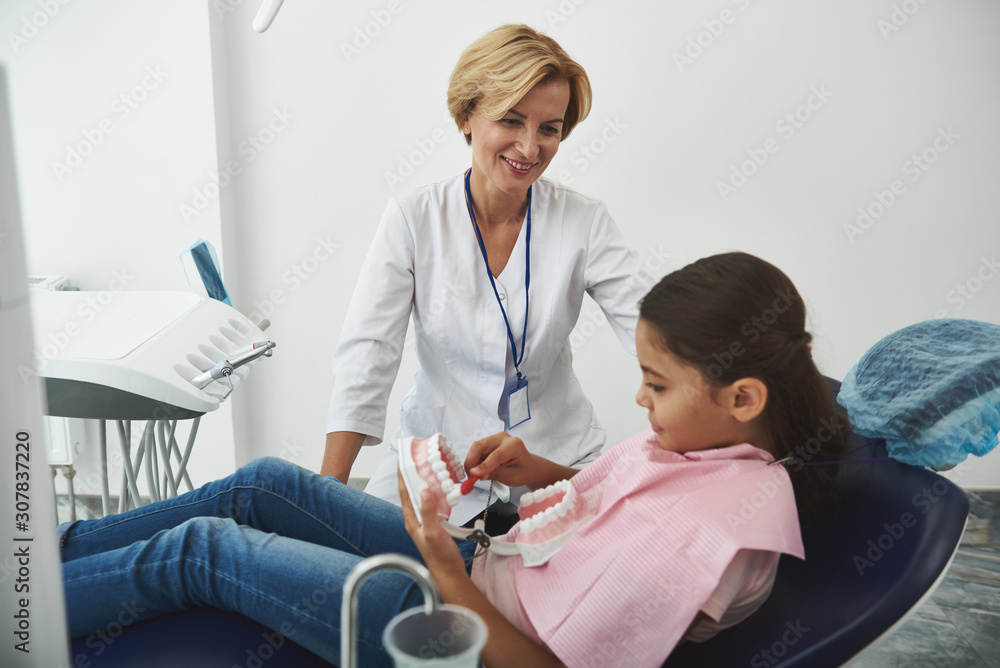 Cheerful female dentist conducting a check up Cheerful female dentist conducting a check up