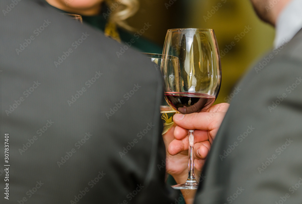Man holding the glass of red wine Man holding the glass of red wine