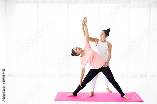 Two Asian woman practice yoga exercise.