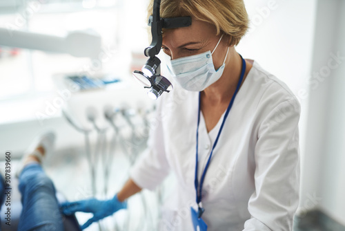 Dentist is examining patient with special equipment