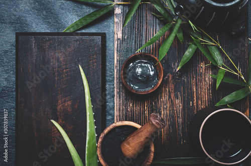 Skincare. Ingredients for mask and scrub with activated charcoal powder and aloe vera, copy space. photo