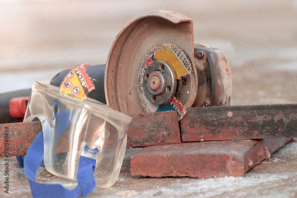 Angle grinder cutting disc element stuck in safety glasses Stock Photo
