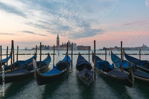 Sunrise of Venice Grand Canal with gondola in foreground on the sea