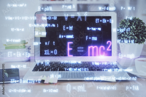 Desktop computer background and formula hologram writing. Double exposure. Education concept.