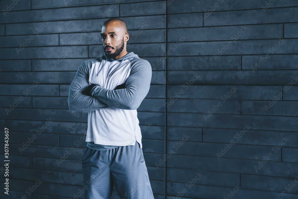 Black confident sportsman standing with arms crossed Black confident sportsman standing with arms crossed