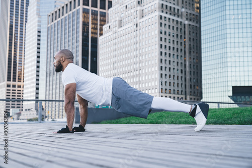 Athletic black man doing plank exercise