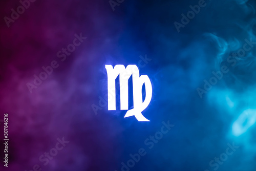 blue illuminated Virgo zodiac sign with colorful smoke on background photo