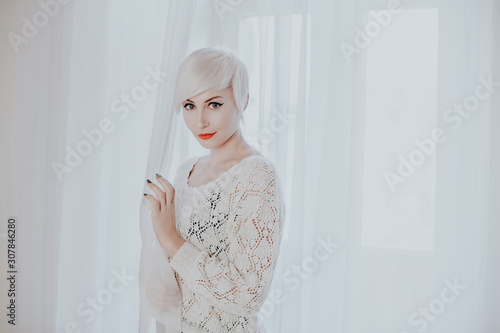 French blonde in a white room fashion photo