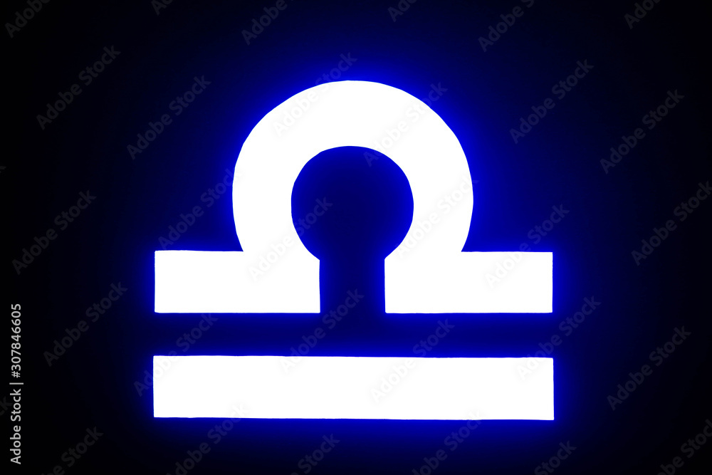 blue illuminated Libra zodiac sign isolated on black blue illuminated Libra zodiac sign isolated on black