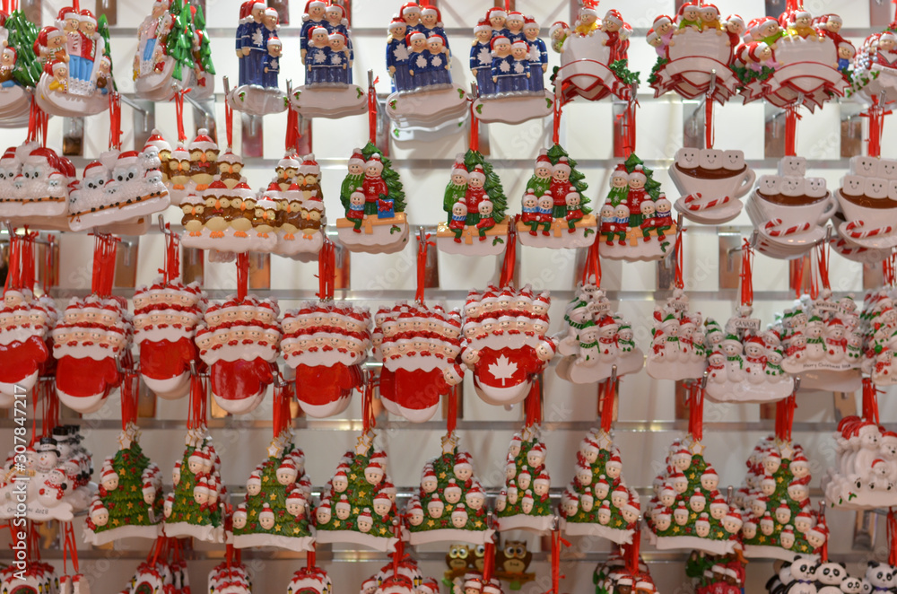 Cute Santa Claus toy dolls key chains placed in a shelf for gifting to during Christmas season in winters. Little Santa figurines are popular gifts for kids during the festivities Cute Santa Claus toy dolls key chains placed in a shelf for gifting to during Christmas season in winters. Little Santa figurines are popular gifts for kids during the festivities