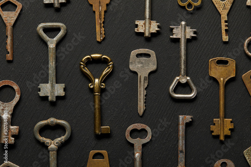 top view of vintage rusty keys on black background © LIGHTFIELD STUDIOS