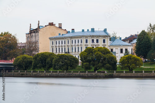Embankment of the 30th Guards Corps with trees and apartment buildings in overcast day, Vyborg, Leningrad Oblast, Russia