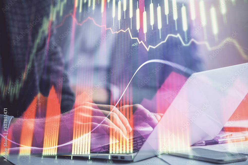 Double exposure of market chart with man working on computer on background. Concept of financial analysis. Double exposure of market chart with man working on computer on background. Concept of financial analysis.