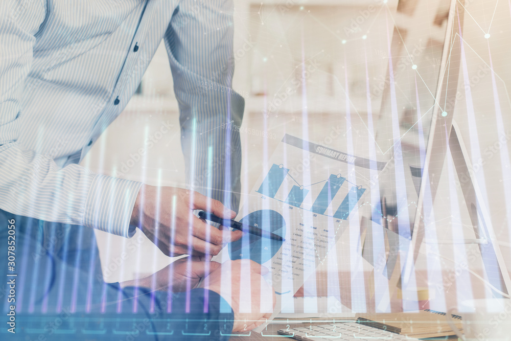 Double exposure of chart with businessman typing on computer in office on background. Concept of hard work. Double exposure of chart with businessman typing on computer in office on background. Concept of hard work.