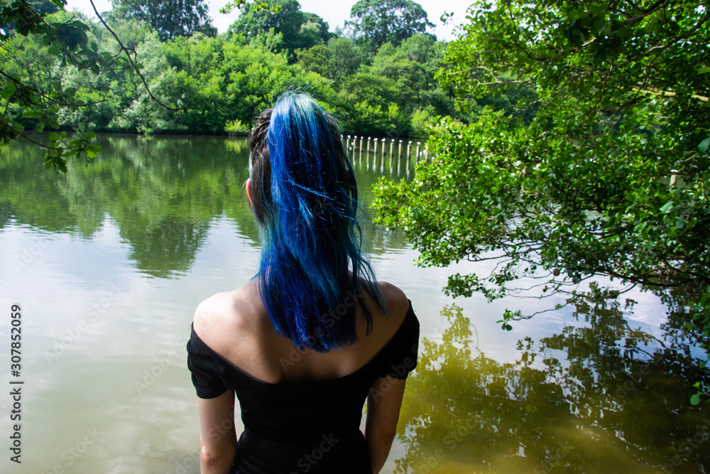 Fototapeta premium A girl looking at the lake