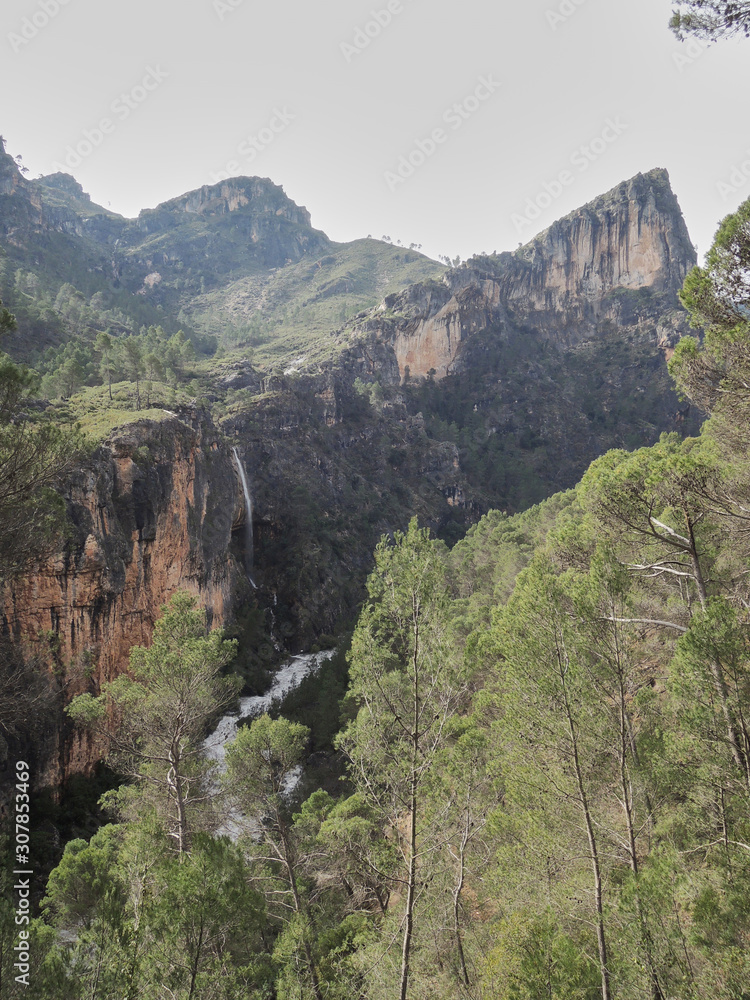 Fototapeta premium A waterfall falls on the Guadalquivir River in the Natural Park of the Sierra de Cazorla, Segura and Las Villas. In Jaén, Andalusia. Spain